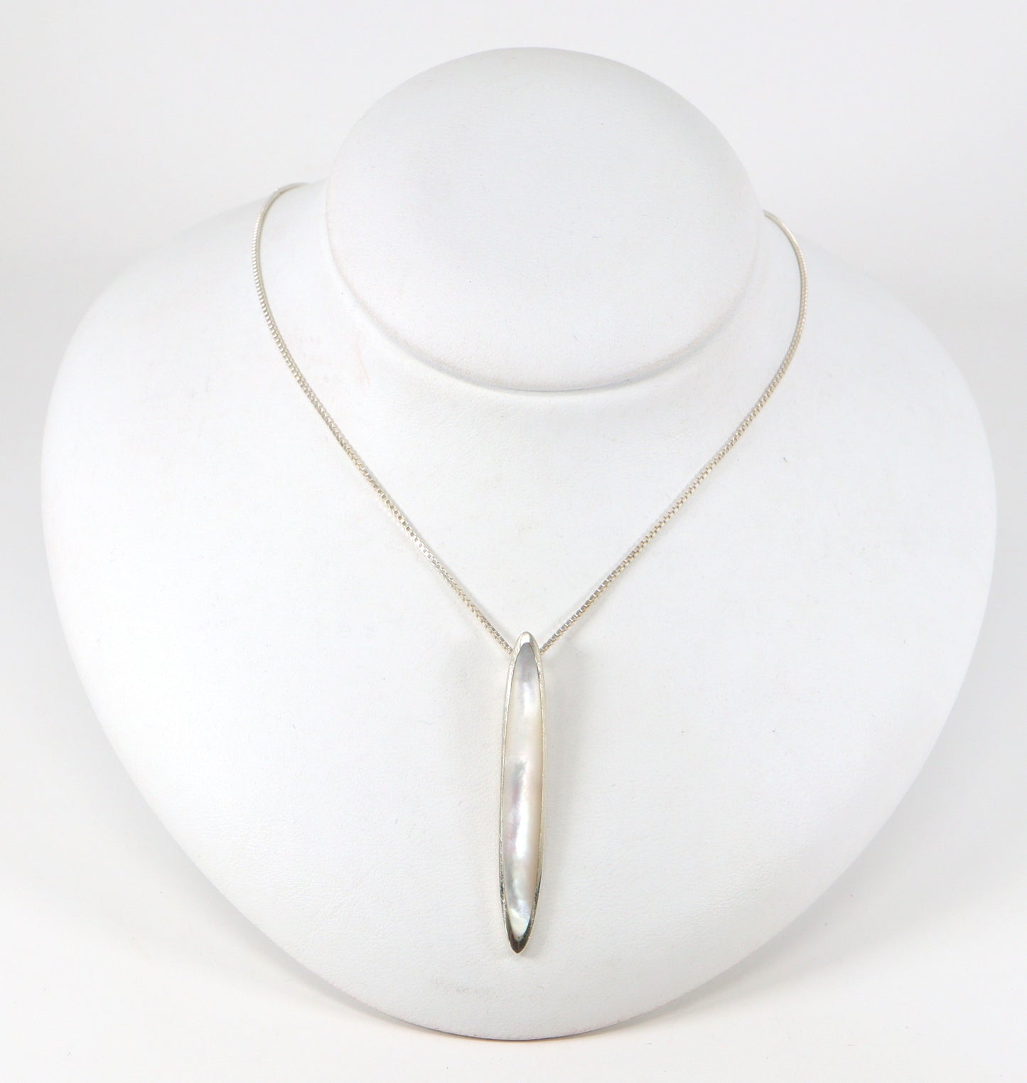 A pretty Silver Mother of Pearl Pendant and Chain. The pendant sits on an 18 inch box chain. The pendant is stamped 925 for sterling silver. The box chain is stamped Italy and 925 for sterling silver.