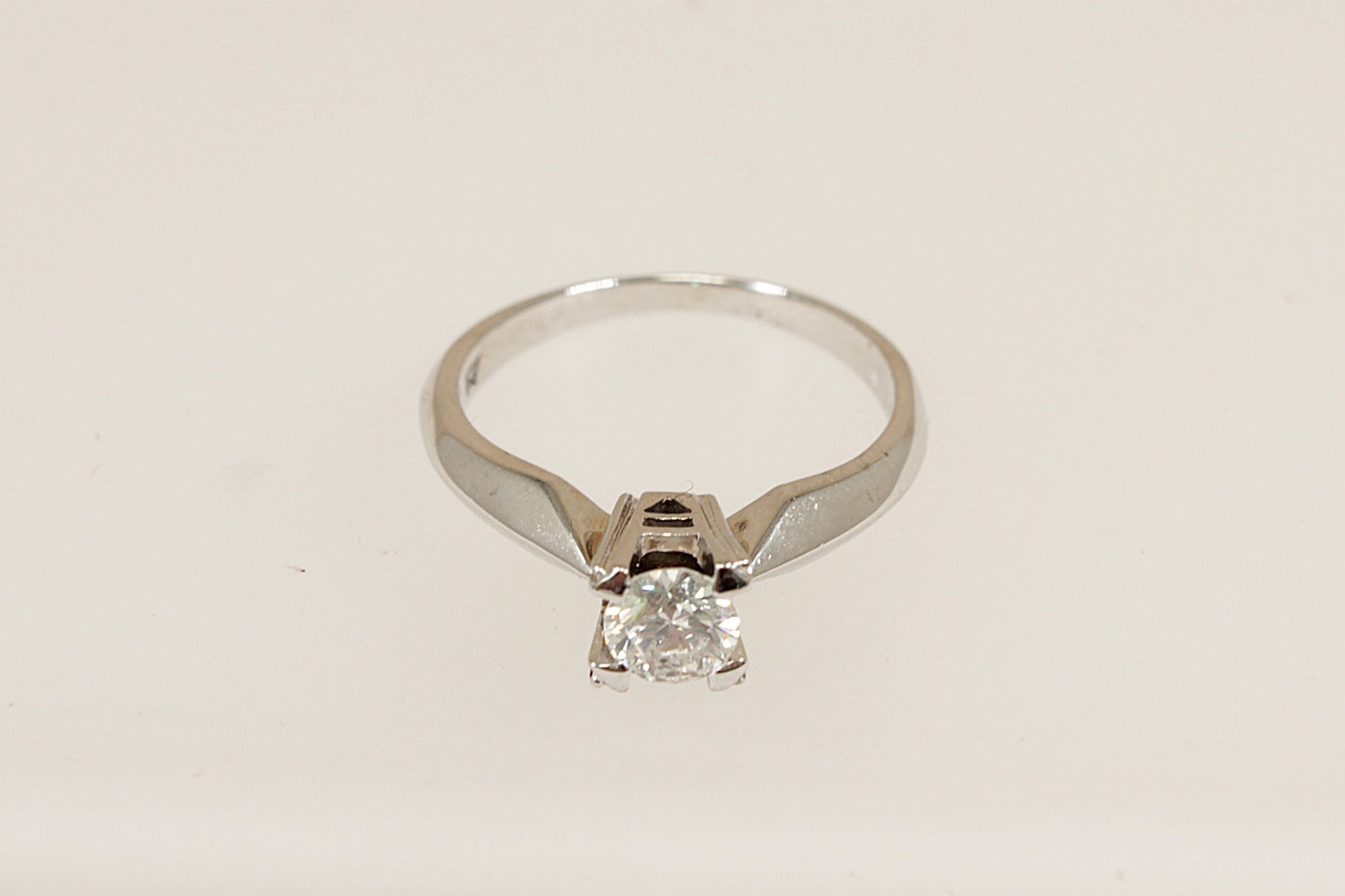 This beautiful, elegant 18ct white gold solitaire ring features a brilliant 0.50ct (estimated) round diamond, securely held in a robust four-claw crown setting. Inside the band, the ring is stamped "750" for 18ct gold and bears the distinctive WM maker’s mark, perfect as an engagement ring or as a classic addition to any fine jewellery collection. UK finger size N.
