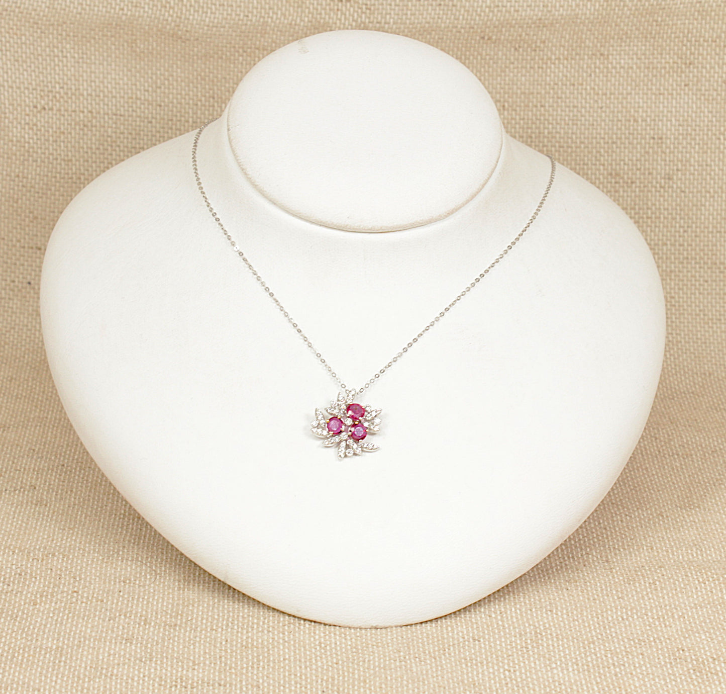 18ct white gold diamond and ruby pendant necklace stamped 0.93 carat for the rubies and 0.32 carat for the diamonds the pendant sits on a 18ct white gold 18 inch chain.