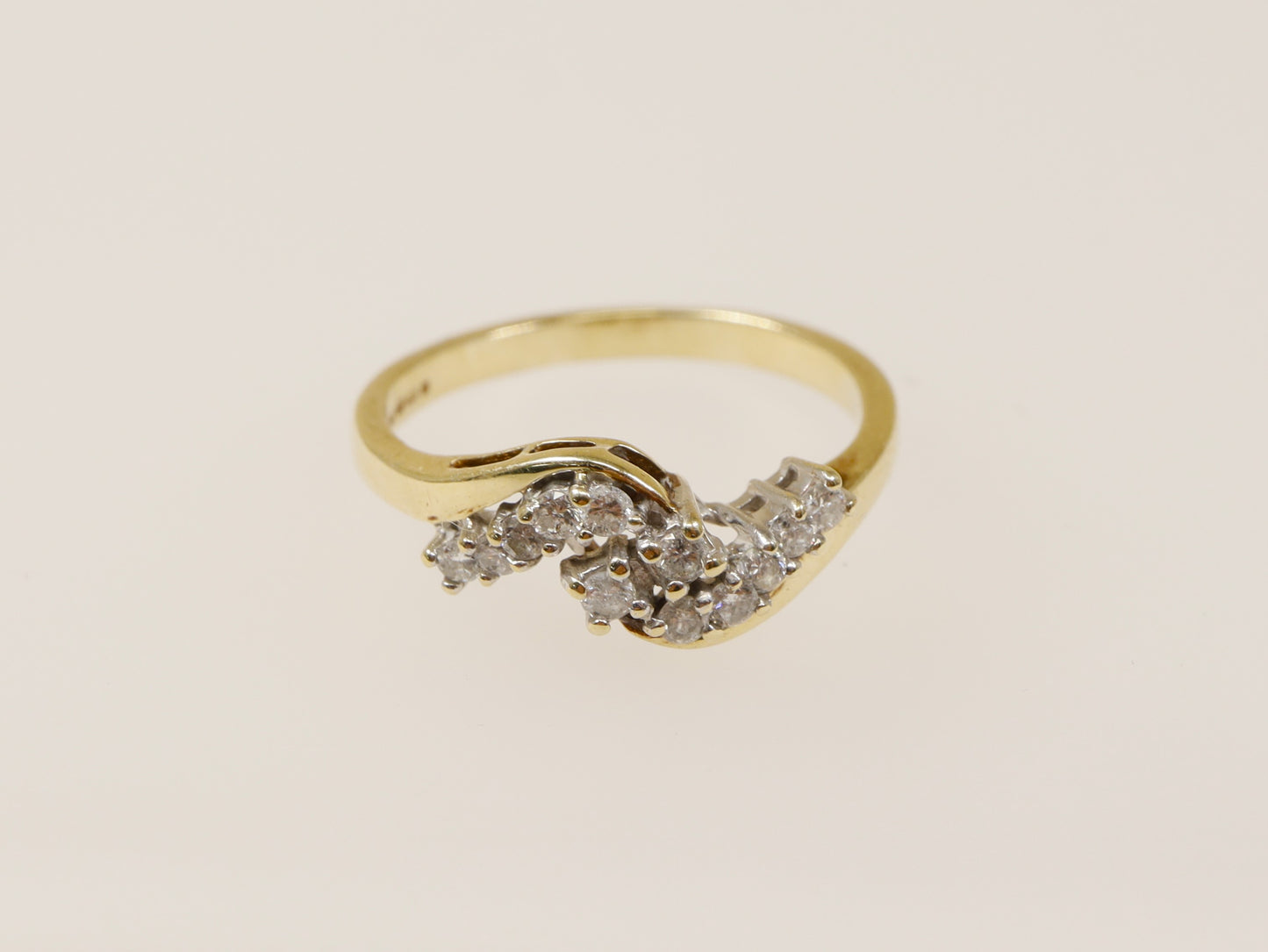 A 9ct gold diamond cluster ring with three bands of natural diamonds set in a twist design. UK finger size N.