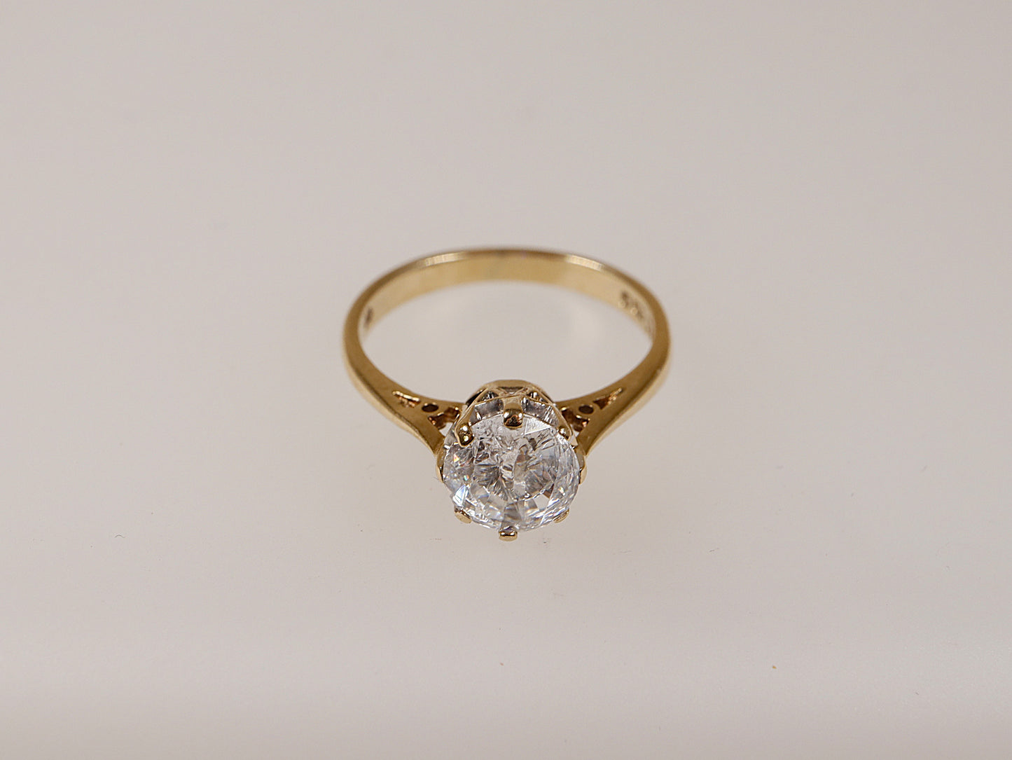 A vintage 9ct gold solitaire ring with a central cubic zirconia stone, displayed against a white background.