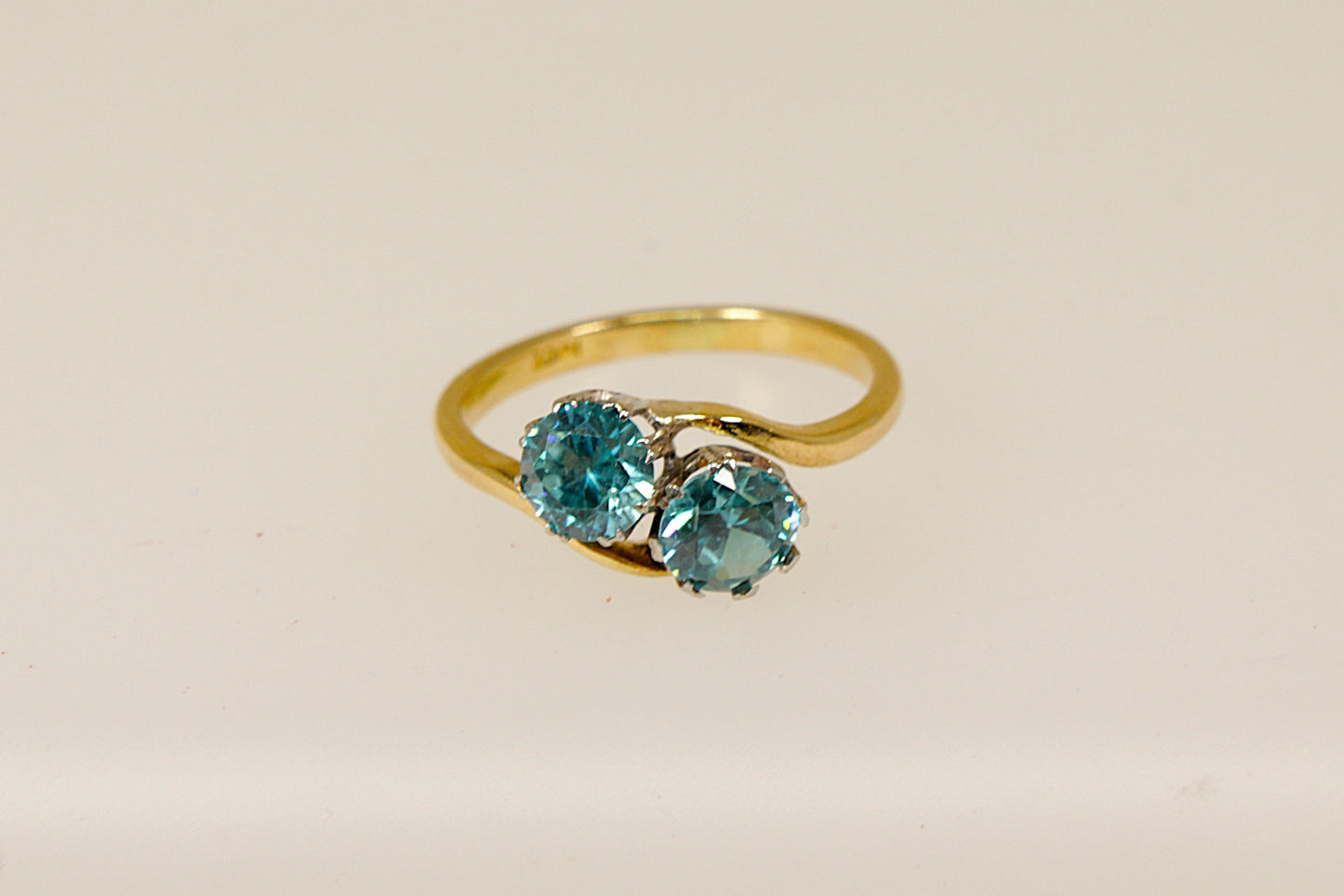 A vintage 18ct gold ring with two old-cut blue zircon gemstones.