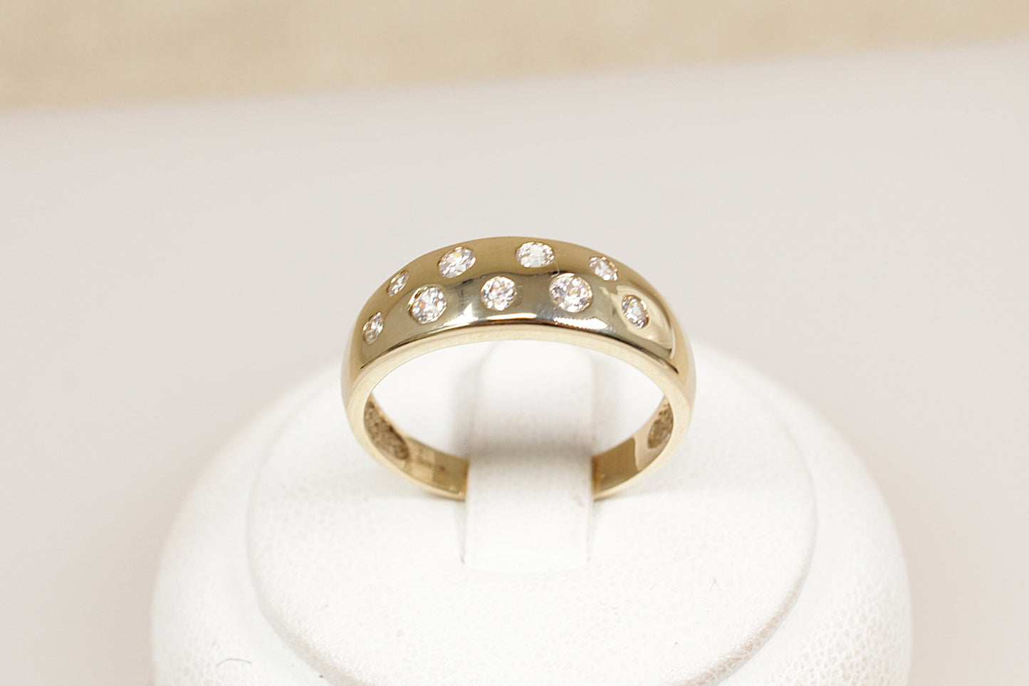 A 9ct Yellow Gold 9 stone scatter band ring.