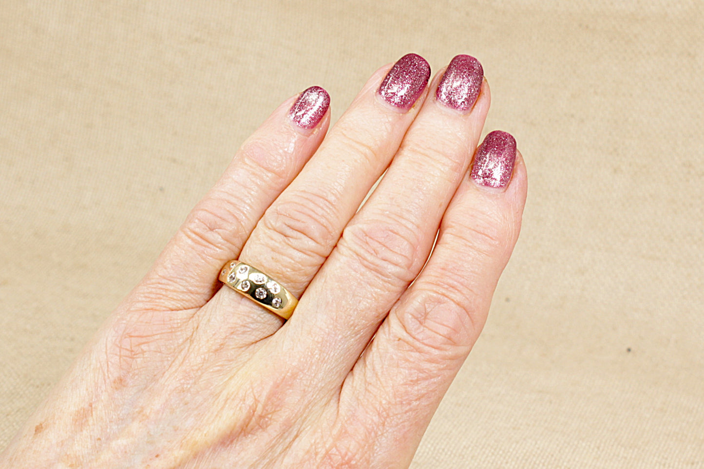 A 9ct Yellow Gold 9 stone scatter band ring.