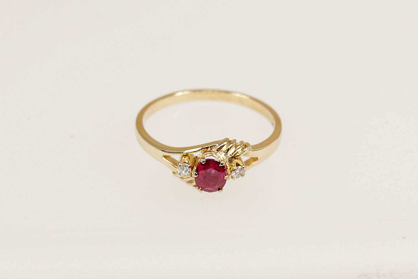 18ct yellow gold ruby and diamond trilogy ring.