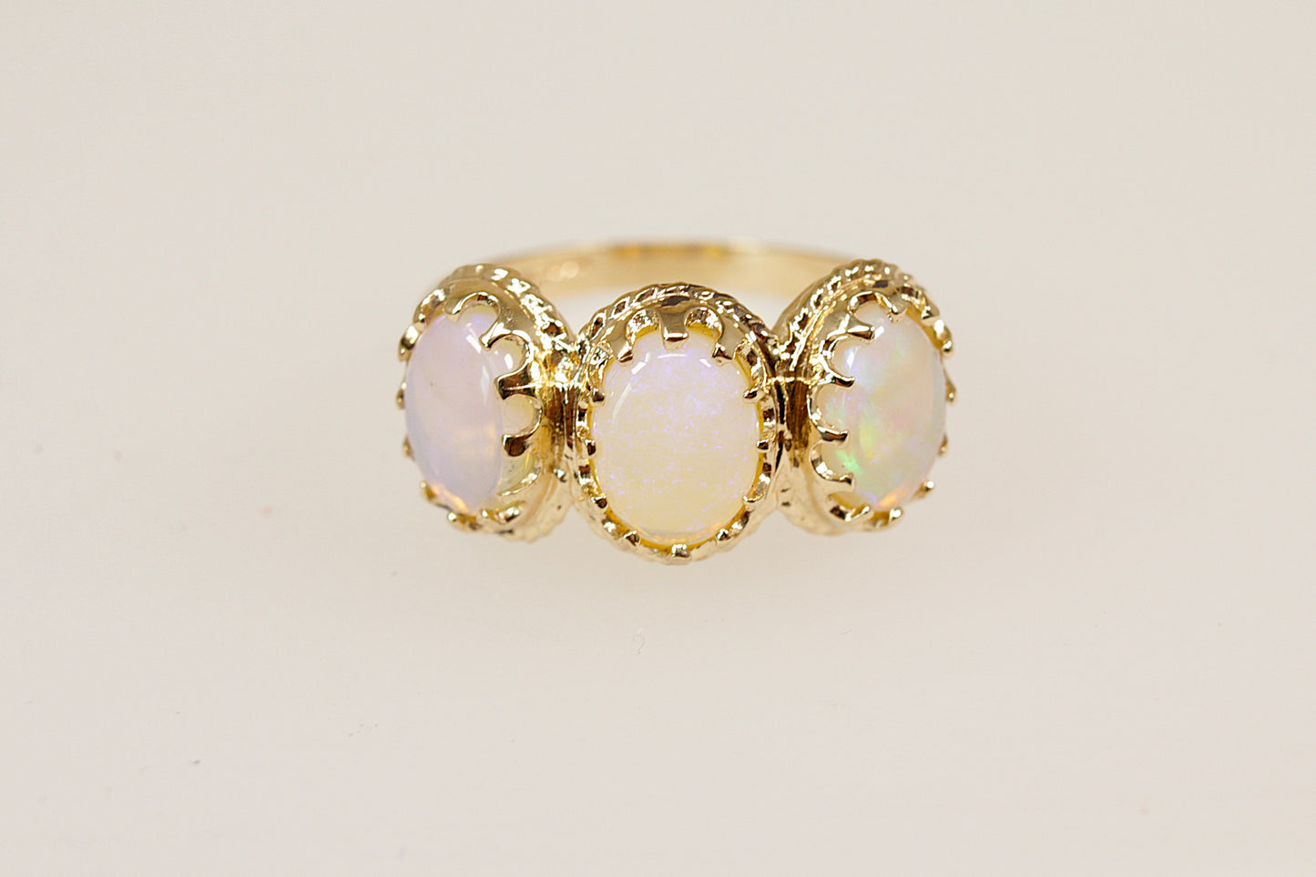 9ct yellow gold opal trilogy ring.