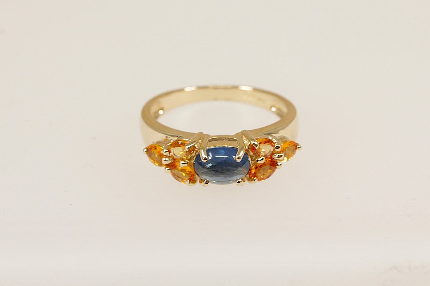 9ct yellow gold blue sapphire and orange topaz gemstone set ring.
