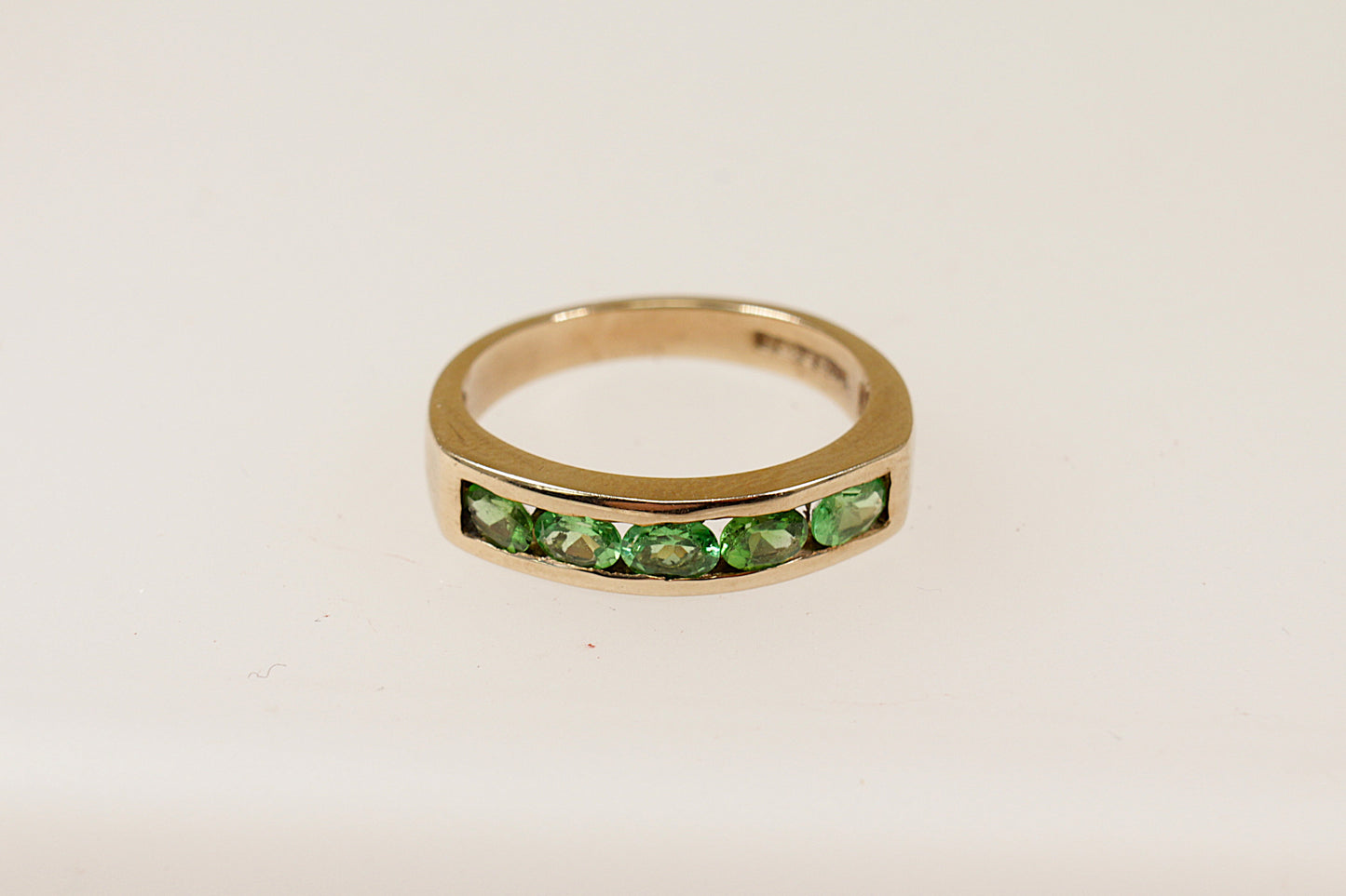 This stunning ring is crafted in 9ct gold, providing a warm and elegant base that enhances the vibrant green colour of the 9 Tsavorite Garnets, Tsavorite were dicovered in Northern Tanzania and across the border in Kenya.
Named after Tsavo national park where they are still mined today.
UK finger size P.