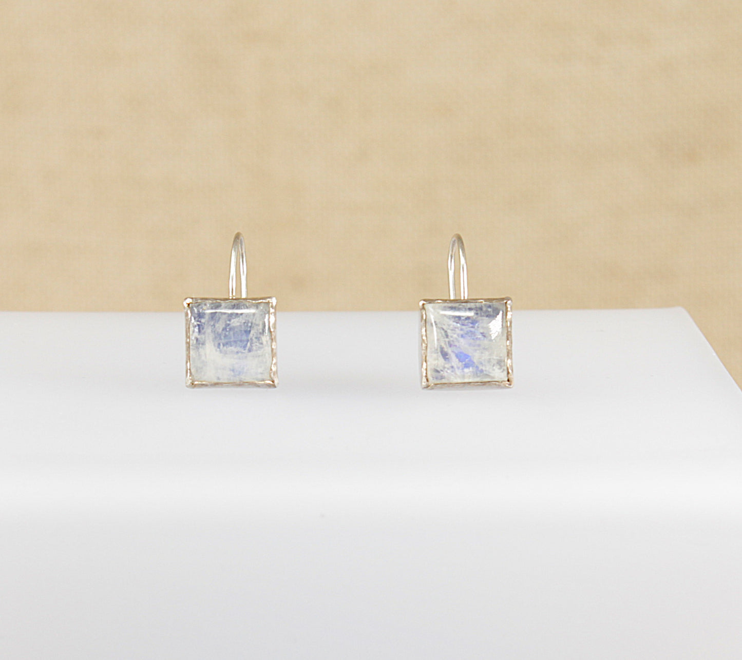 These beautiful Moonstone earrings are square shaped and have a bold appearance that is bezel set with an artisan ‘studio’ feel. The moonstone has lovely blue flashes of iridescence.