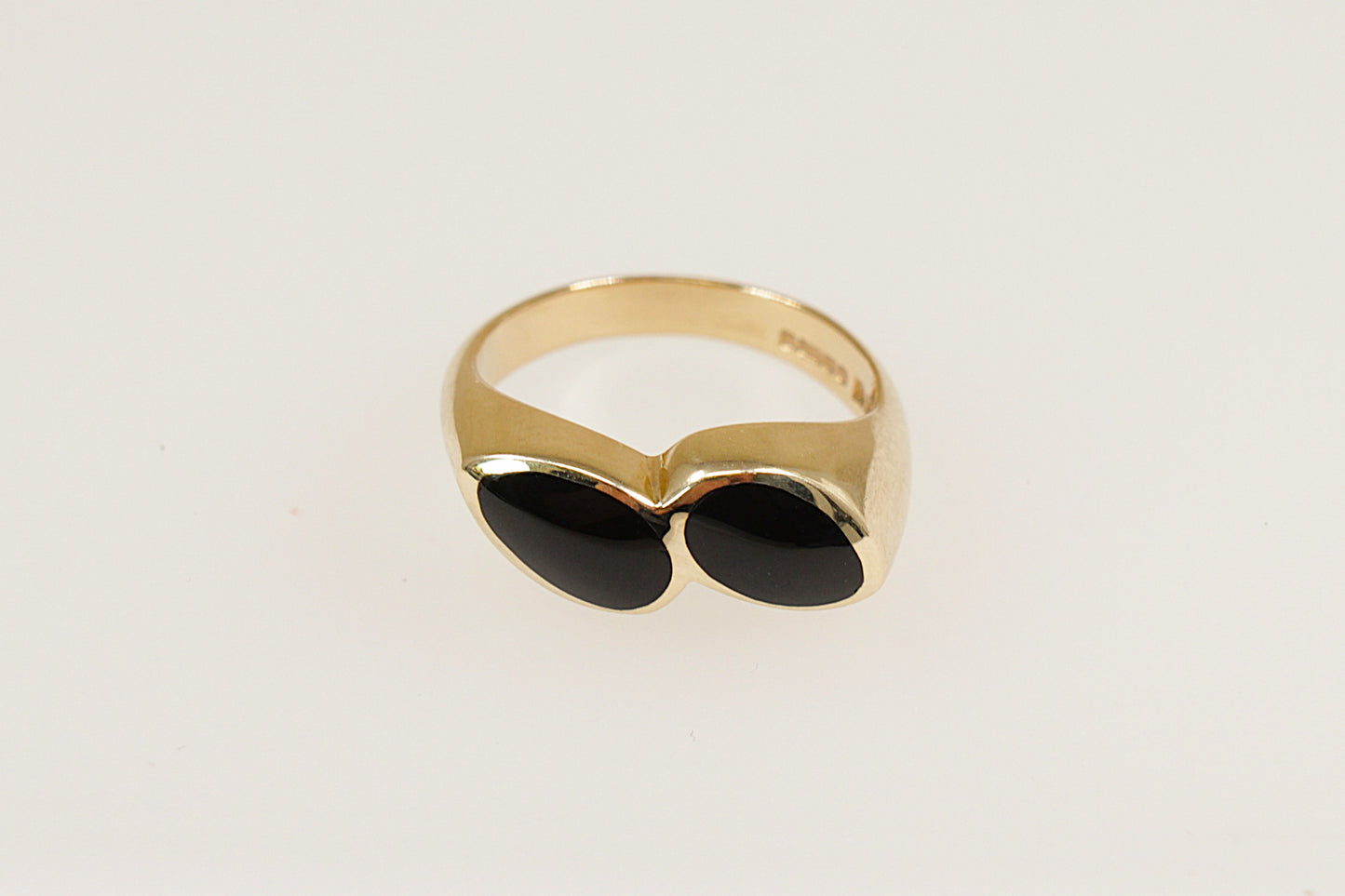 A 9ct gold ring with two pear-shaped pieces of black Whitby Jet, bezel set side by side at a subtle angle.