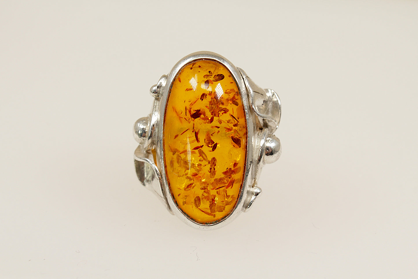 Baltic amber silver statement ring, On the outside of the band it has continental hallmarks, Polish? with the 925 stamp for sterling silver and the letters DC. UK finger size M.