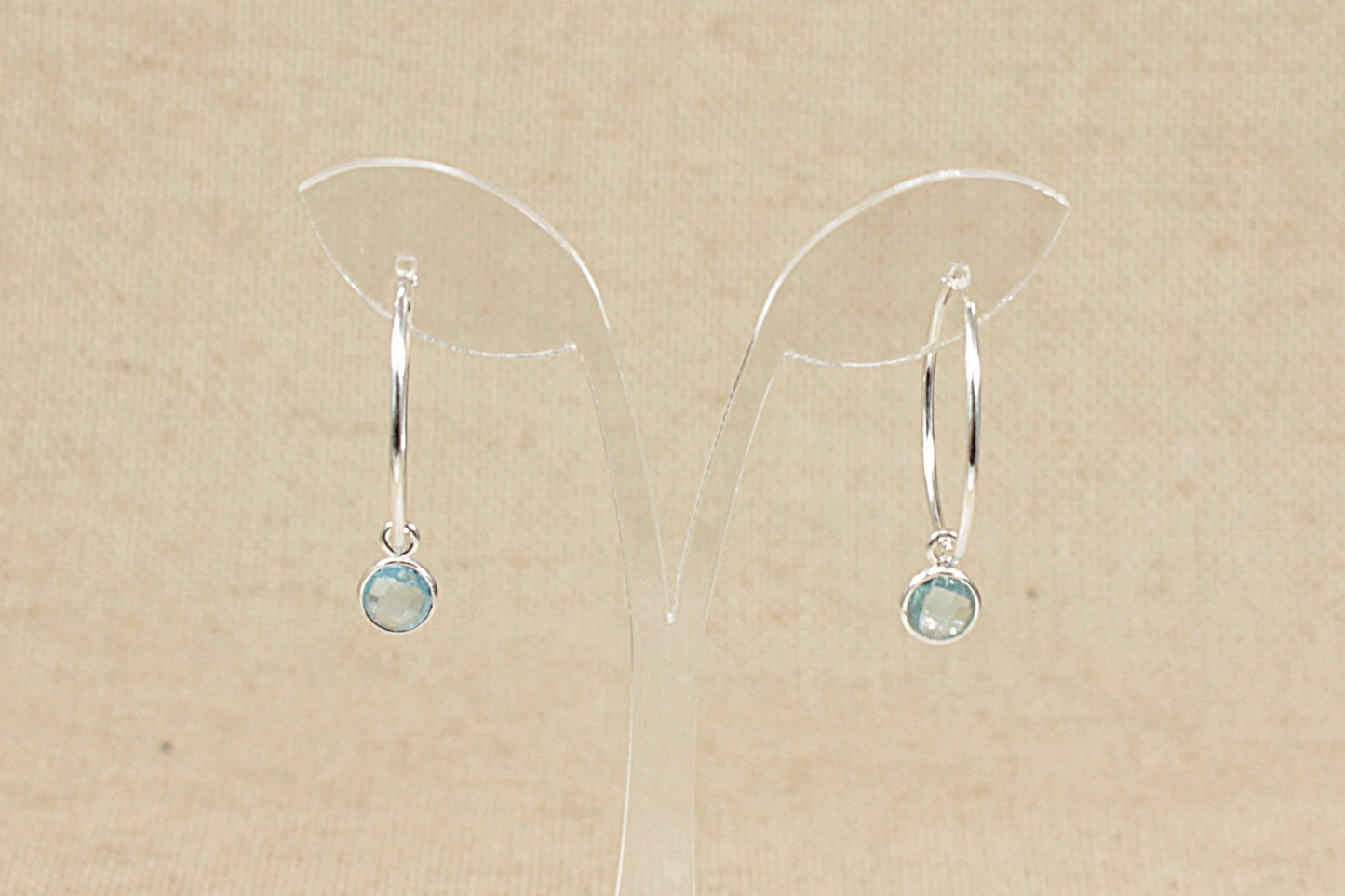 silver hoop earrings with blue topaz dropper rear view