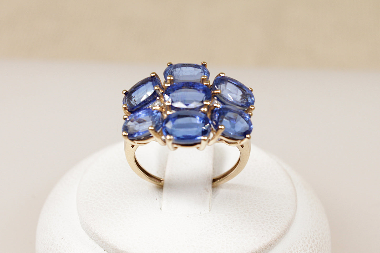 A 9ct gold ring featuring a cluster of oval-cut London blue topaz gemstones with diamond accents, The ring is in excellent condition and inside the band it has Birmingham hallmarks for 9ct Gold. UK Finger size L ½.