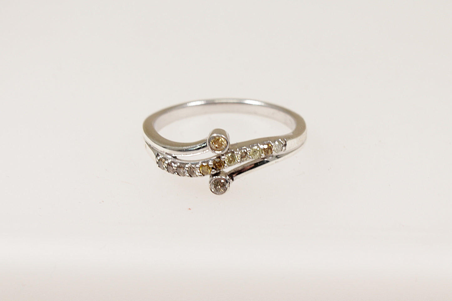 The main feature of this beautiful Silver ring is a wavy band design set with shimmering Diamonds, adding a sense of movement and flow to the piece. Two additional diamonds are set on each side of the band framing the wavy design and enhancing the overall sparkle. UK finger size S.