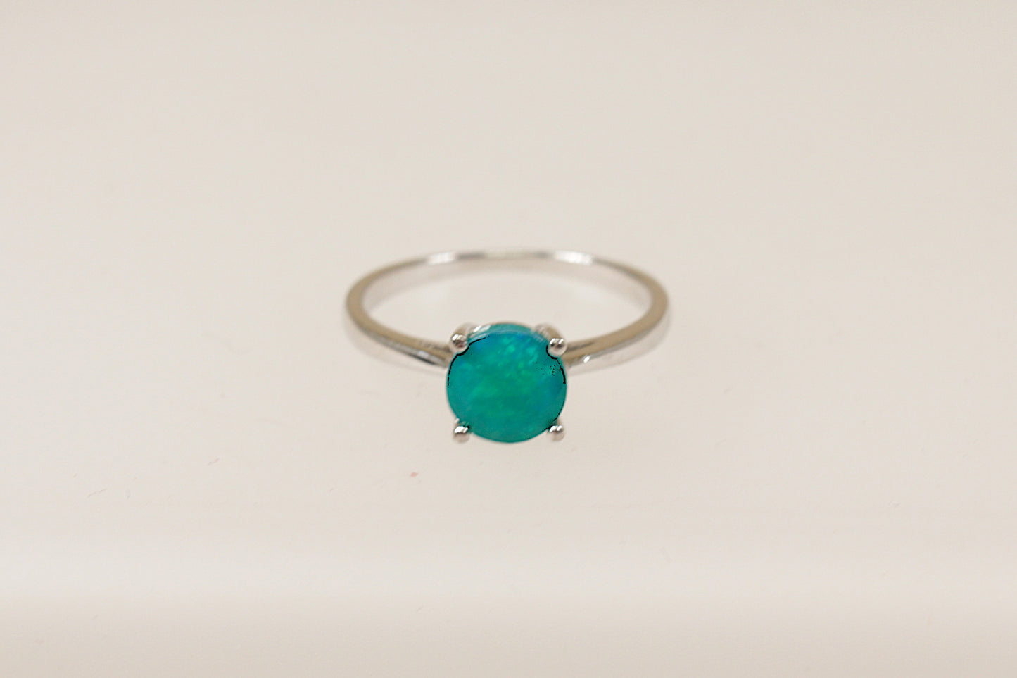 This pretty Silver ring has a captivating green Crystal gemstone that is claw set and shimmers in the light. It is in excellent condition and inside the band it is stamped 925 for sterling silver. UK Finger size: O