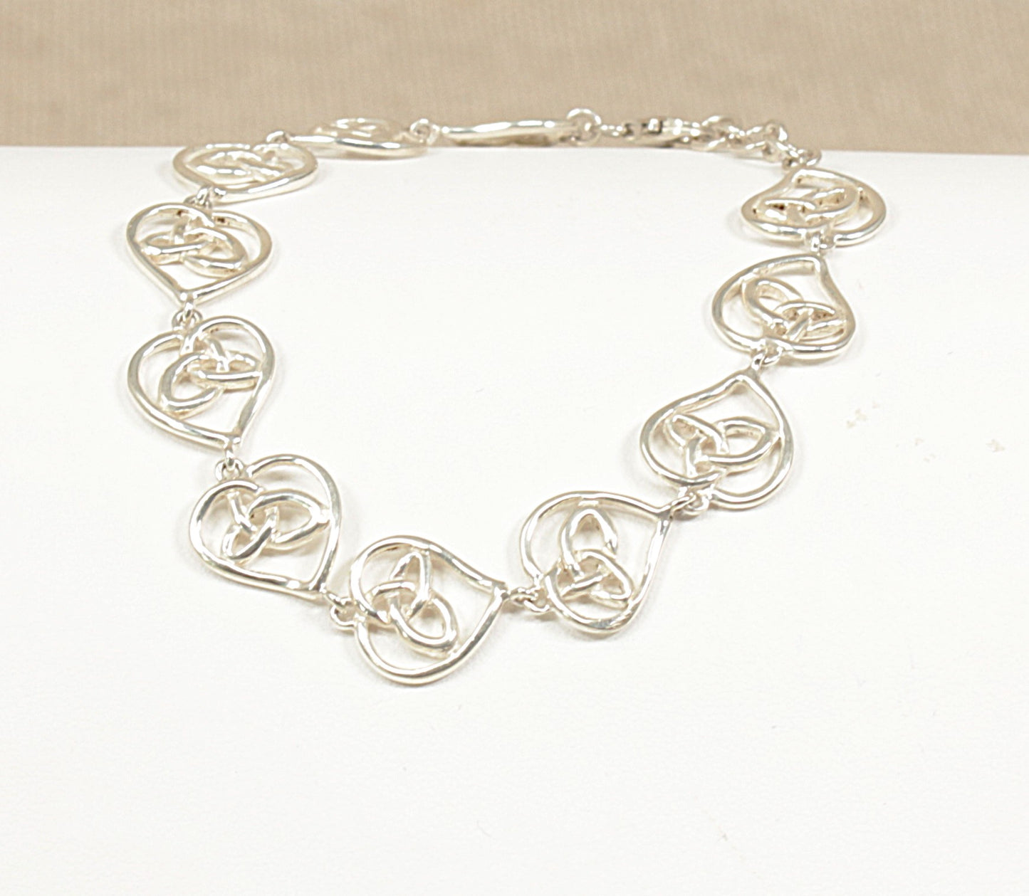 Silver Bracelet-with heart shaped links on a white background