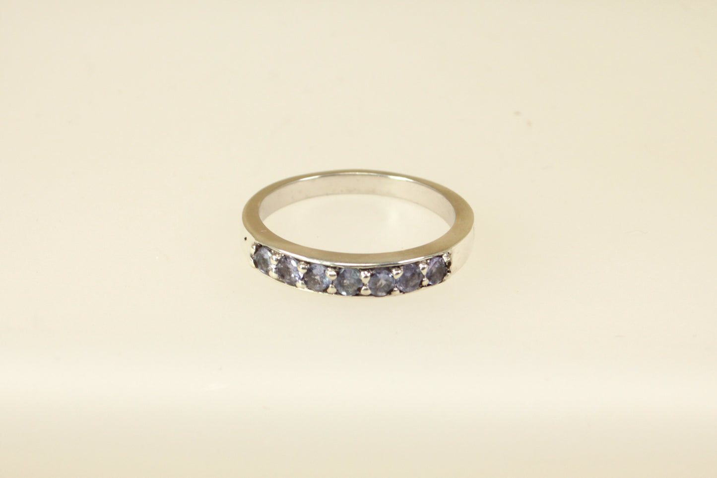 This pretty silver ring has 7 round Iolite gemstones set in handcrafted silver across the band. It is in excellent condition and inside the band it is stamped 925 for sterling silver. Band width: 4mm
UK Finger size: S