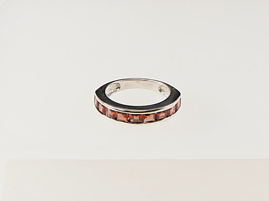 This lovely Sterling Silver Garnet band ring has 9 square cut channel set Garnets.
It is in great condition and has 925 stamped on the inside of the band for Sterling Silver.
UK Finger size: N 1/2