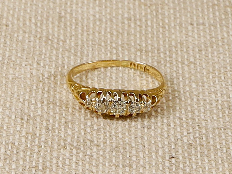 A stunning Antique 18ct 5 stone Diamond Ring with old cut Diamonds.
The ring is stamped inside the band with London hallmarks and 18 for 18ct gold. In our opinion we estimate this ring to be circa 1900. Weight of Diamonds 0.30 carat (estimated). 
UK Finger size P.