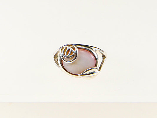 A sterling silver ring with a pink shell in a leaf-inspired mount, stamped 925.