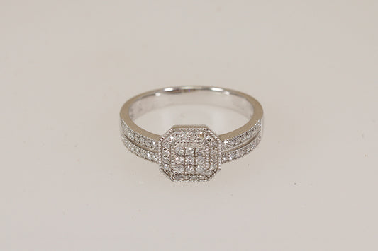 White gold diamond ring with diamond accents on a light beige background