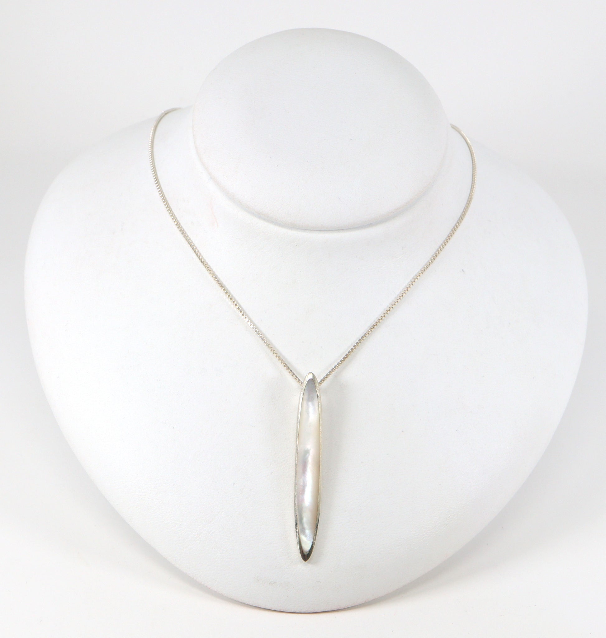 A pretty Silver Mother of Pearl Pendant and Chain. The pendant sits on an 18 inch box chain. The pendant is stamped 925 for sterling silver. The box chain is stamped Italy and 925 for sterling silver.