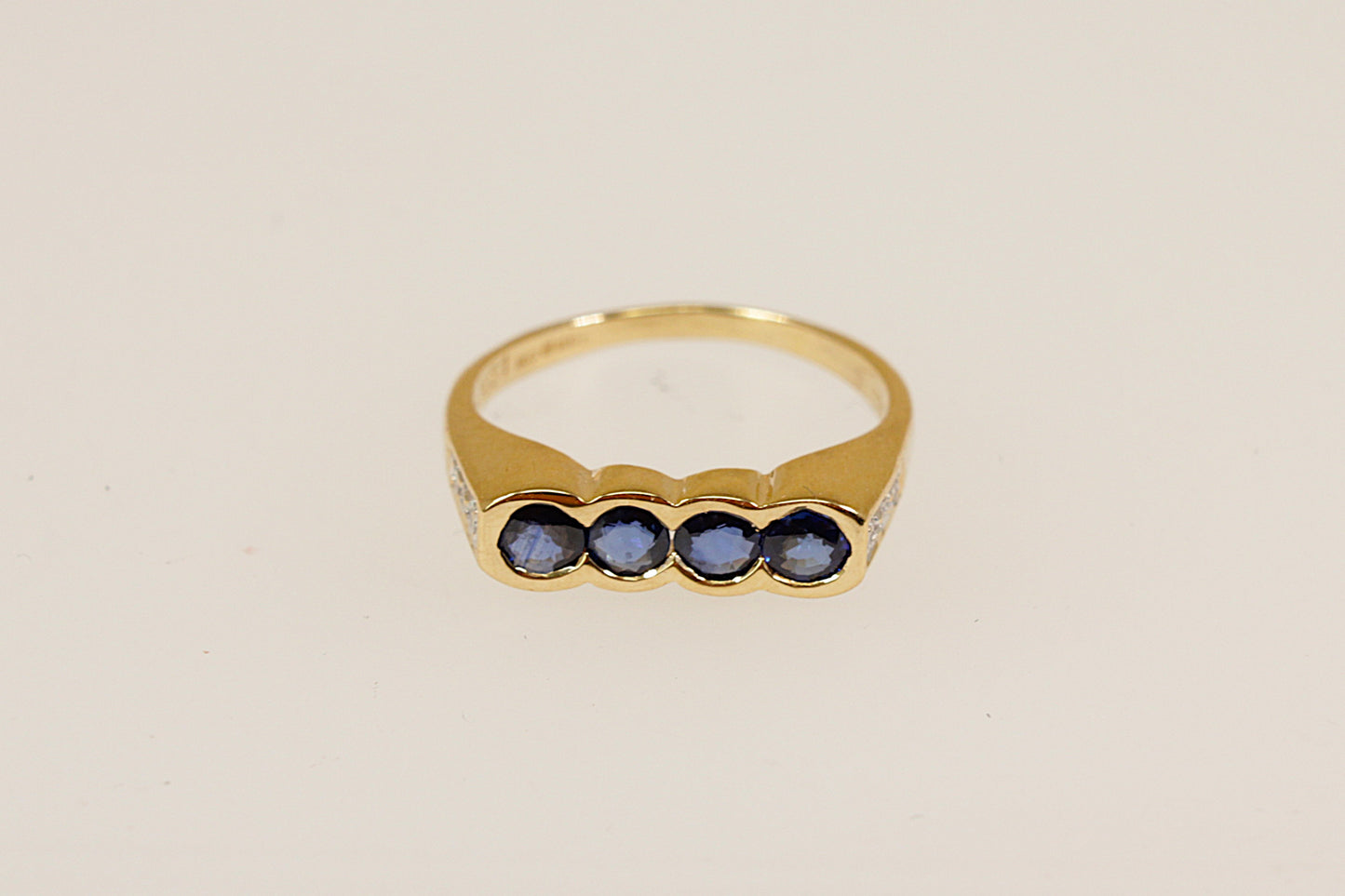 18ct four Sapphire gemstone and diamond set shoulders ring Sheffield hallmarks for 18ct gold and dated 1994 UK finger size M this ring is an ideal pinky little finger ring unisex male or female.