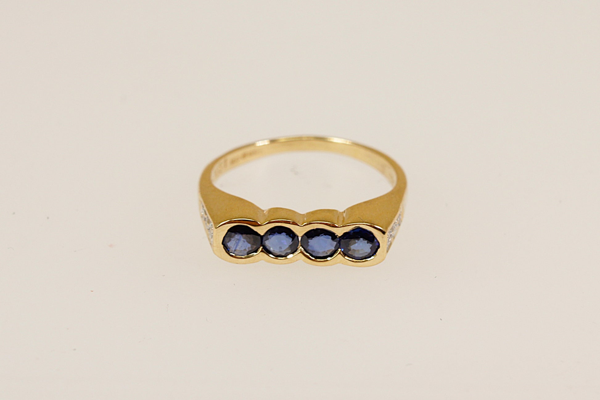 18ct four Sapphire gemstone and diamond set shoulders ring Sheffield hallmarks for 18ct gold and dated 1994 UK finger size M this ring is an ideal pinky little finger ring unisex male or female.