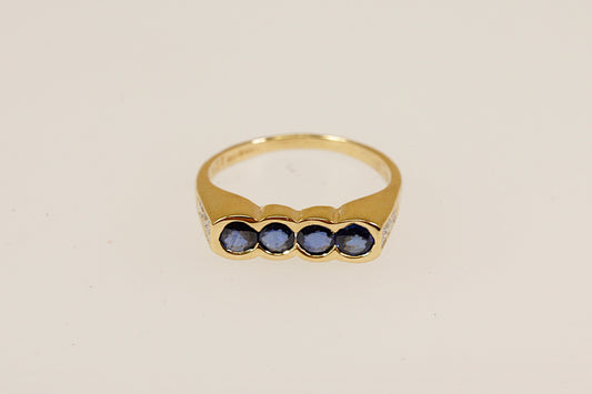 18ct four Sapphire gemstone and diamond set shoulders ring Sheffield hallmarks for 18ct gold and dated 1994 UK finger size M this ring is an ideal pinky little finger ring unisex male or female.