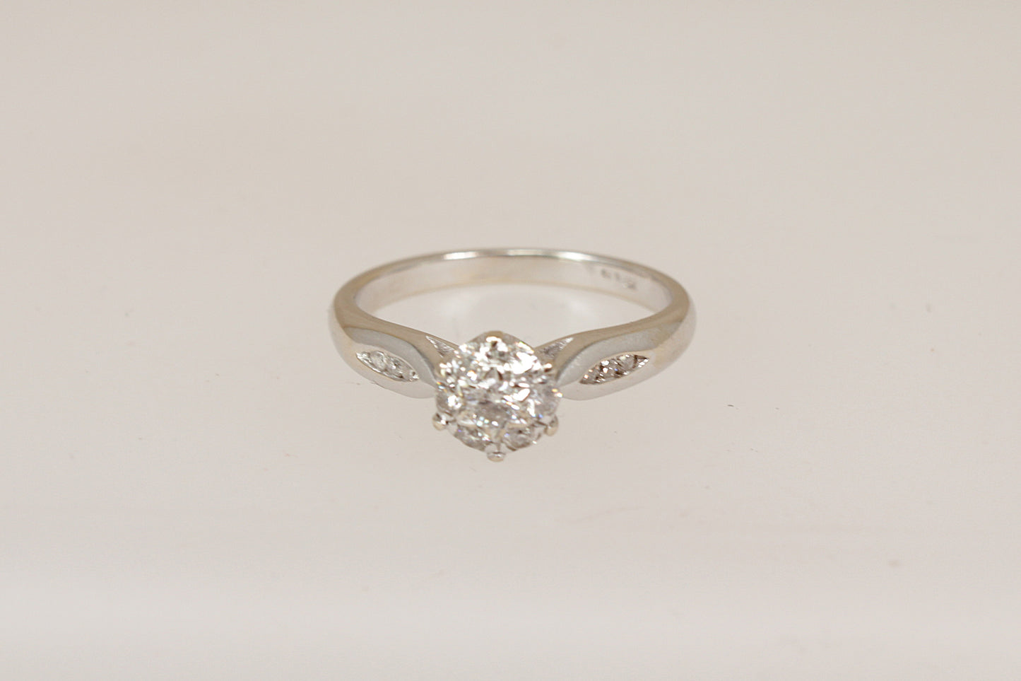 18ct white gold diamond cluster ring  on a light gray background