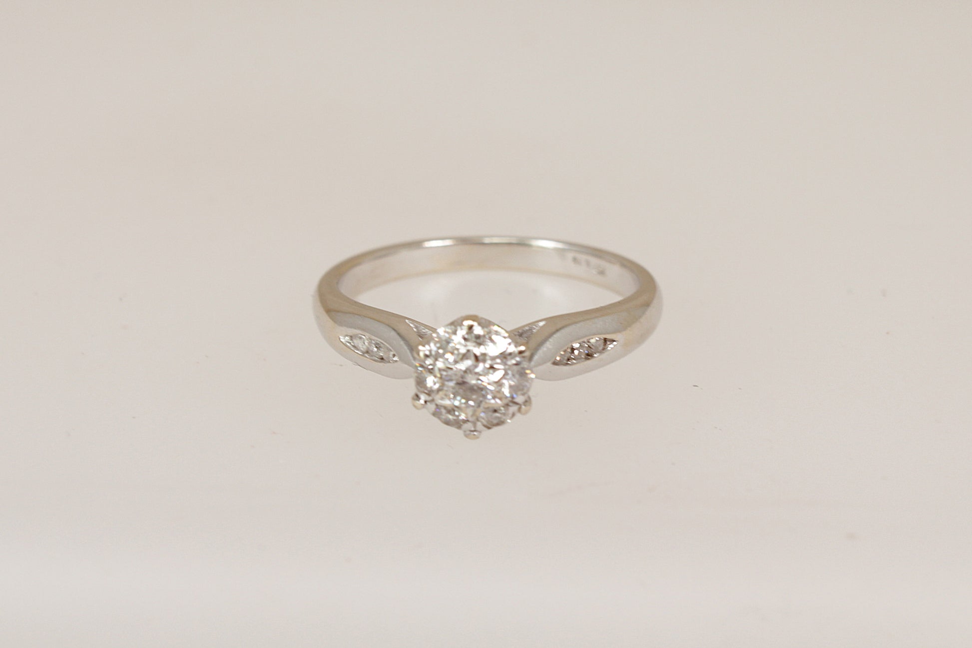 18ct white gold diamond cluster ring  on a light gray background