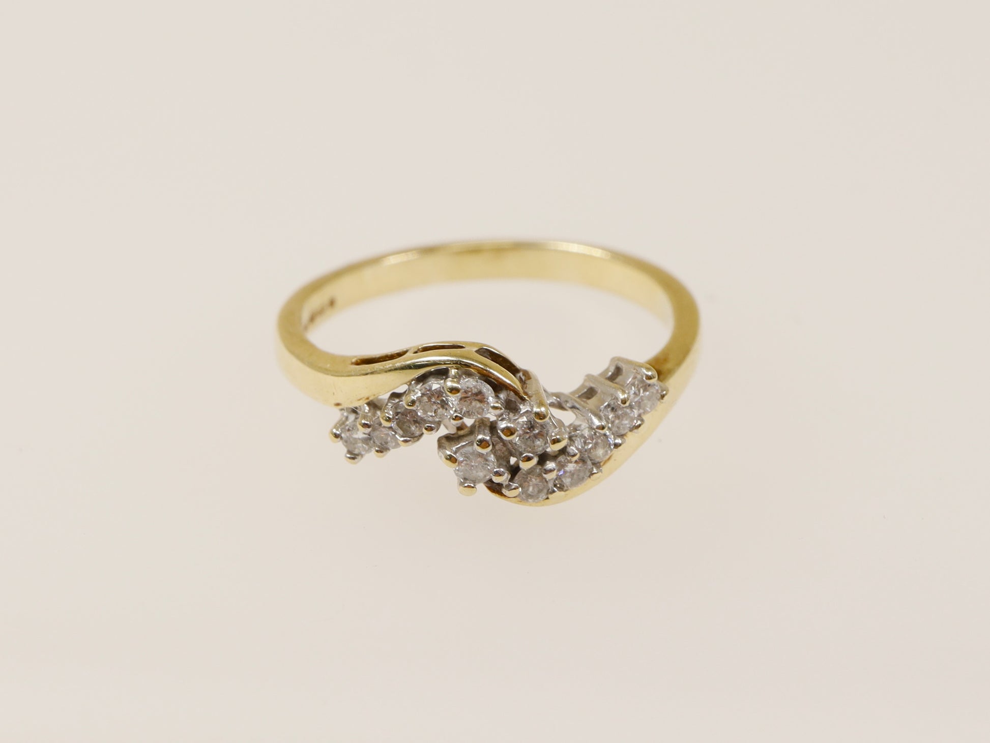A 9ct gold diamond cluster ring with three bands of natural diamonds set in a twist design. UK finger size N.