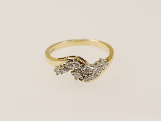 A 9ct gold diamond cluster ring with three bands of natural diamonds set in a twist design. UK finger size N.
