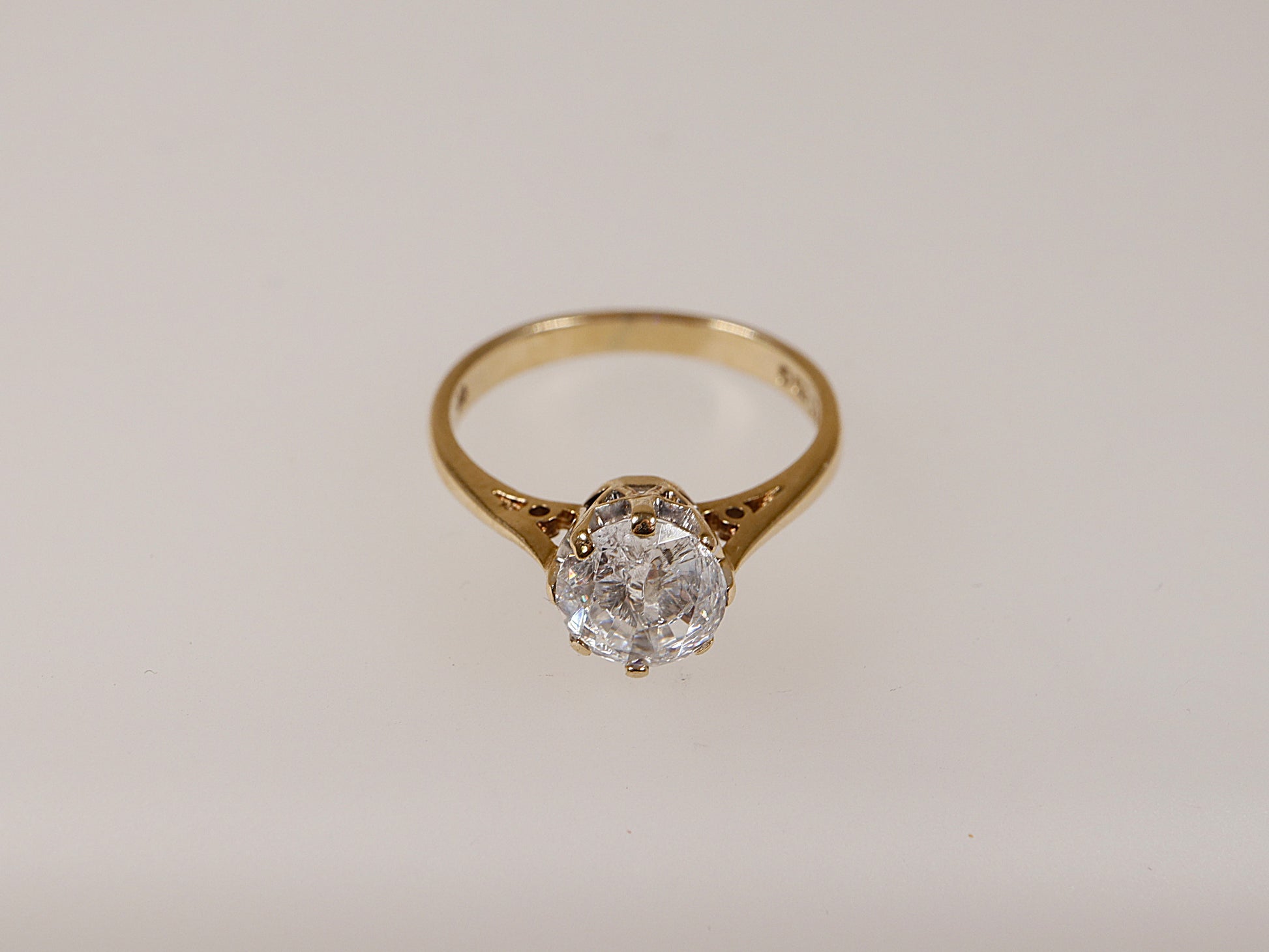 A vintage 9ct gold solitaire ring with a central cubic zirconia stone, displayed against a white background.