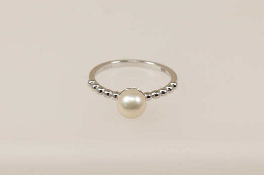 A sterling silver cultured pearl solitaire ring, Stamped 925 for sterling silver and the makers mark ‘TGGC’ for The Genuine Gemstone Company, UK finger size N.