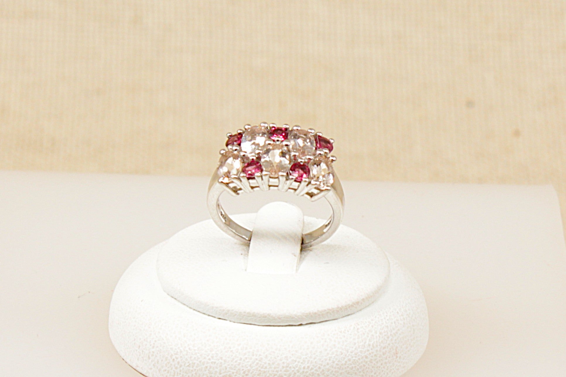 A silver red and clear crystal cluster band ring, Stamped 925 for sterling silver and the makers mark ‘TGGC’ for The Genuine Gemstone Company, UK finger size O.