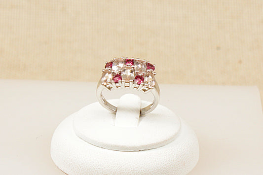 A silver red and clear crystal cluster band ring, Stamped 925 for sterling silver and the makers mark ‘TGGC’ for The Genuine Gemstone Company, UK finger size O.