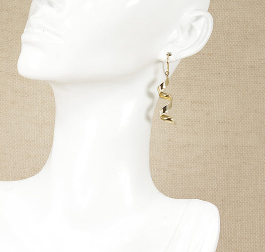 A pair of silver dropper earrings displayed on a mannequin head.