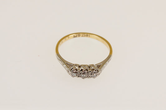 An 18ct Gold and Platinum Diamond Ring with a band of small round diamonds set in a platinum basket on a yellow gold band.