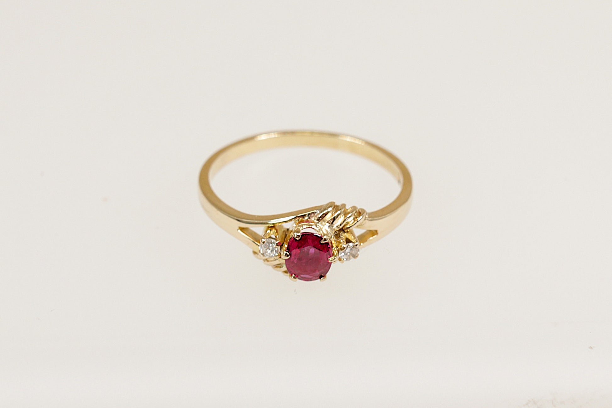 18ct yellow gold ruby and diamond trilogy ring.