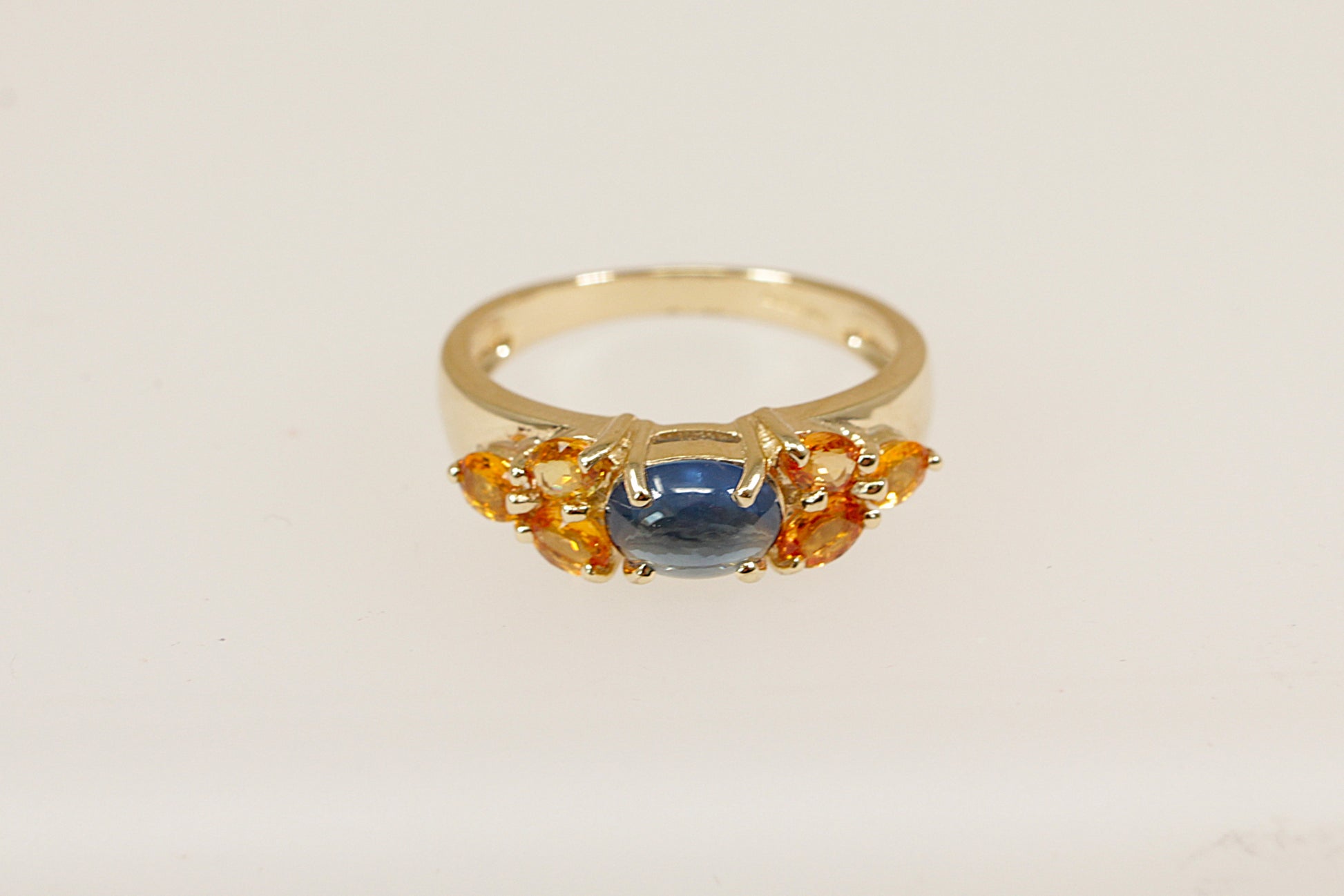 9ct yellow gold blue sapphire and orange topaz gemstone set ring.