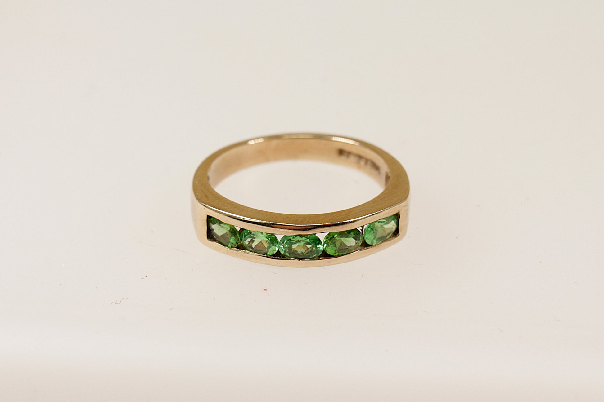 This stunning ring is crafted in 9ct gold, providing a warm and elegant base that enhances the vibrant green colour of the 9 Tsavorite Garnets, Tsavorite were dicovered in Northern Tanzania and across the border in Kenya.
Named after Tsavo national park where they are still mined today.
UK finger size P.