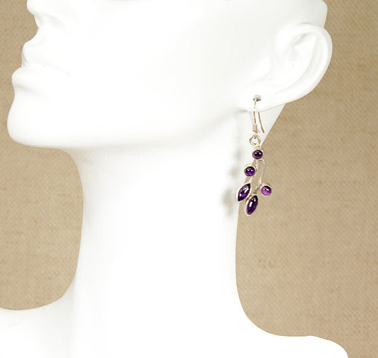 A pair of pretty, floral-inspired cabochon Silver and Amethyst dropper earrings, featuring marquise-cut cabochon gems and round-set stones on silver stalks, combines a delicate, nature-inspired design with the rich colour of amethyst. They are in excellent condition and stamped 925 for sterling silver.
