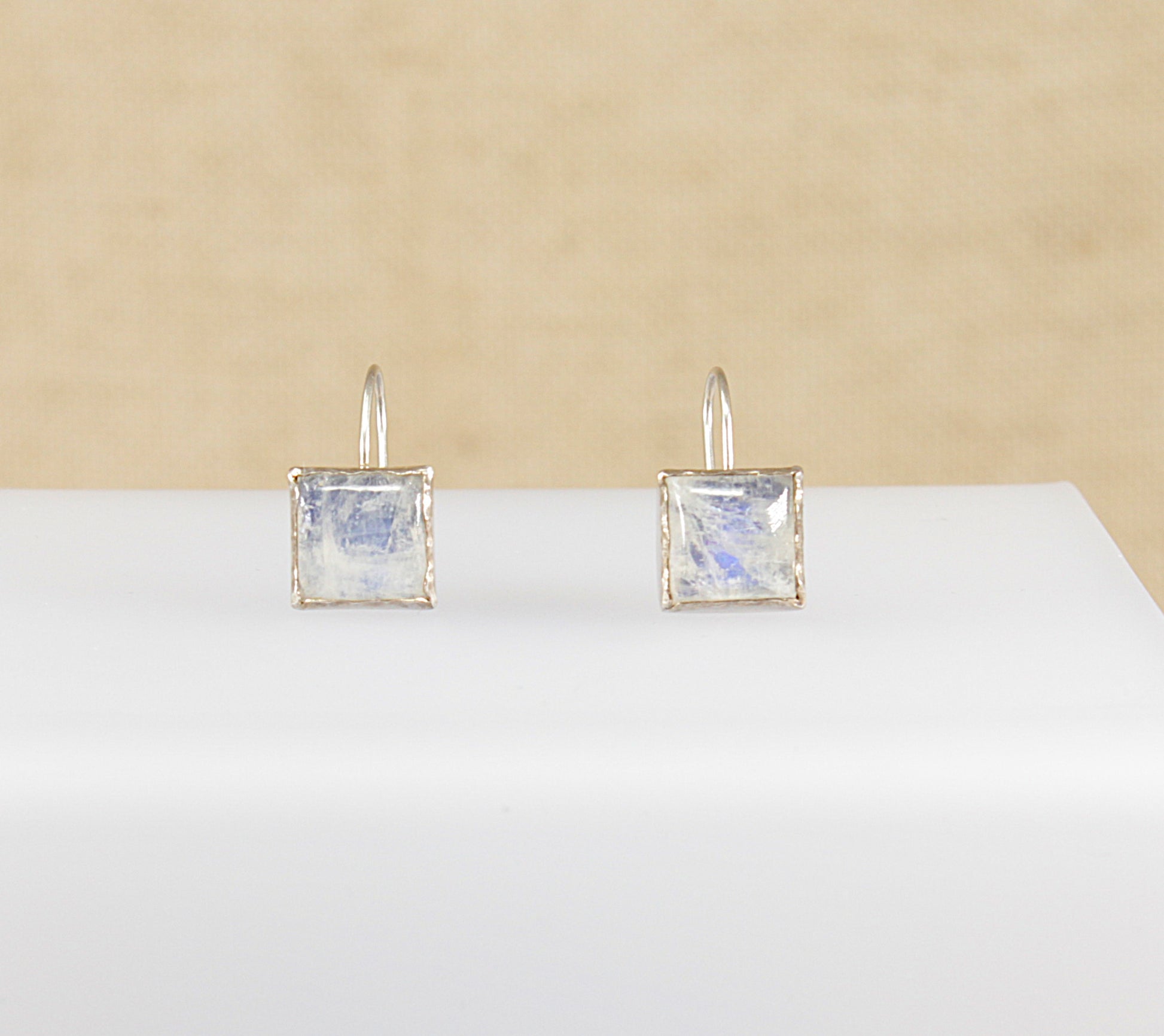 These beautiful Moonstone earrings are square shaped and have a bold appearance that is bezel set with an artisan ‘studio’ feel. The moonstone has lovely blue flashes of iridescence.