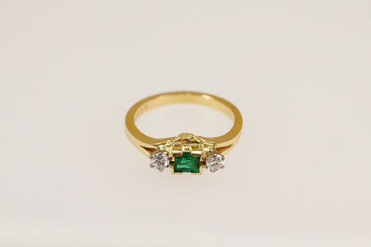 18ct yellow gold emerald and diamond trilogy ring.