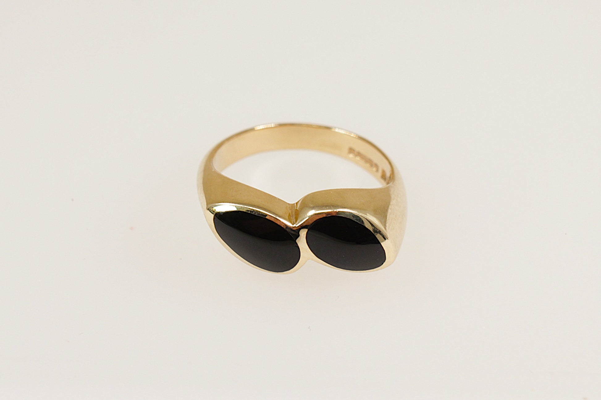 A 9ct gold ring with two pear-shaped pieces of black Whitby Jet, bezel set side by side at a subtle angle.