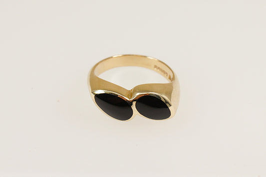 A 9ct gold ring with two pear-shaped pieces of black Whitby Jet, bezel set side by side at a subtle angle.