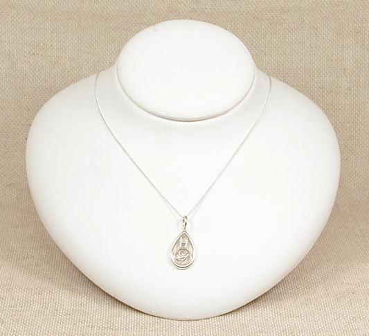 A sterling silver pendant necklace with a teardrop shape featuring a floral and rectangular design on an 18 inch curb chain, displayed on a white mannequin.