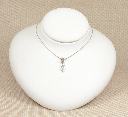 A silver pendant necklace with a geometric and flowing form, displayed on a 16 inch silver snake chain, presented on a white bust against a beige background.