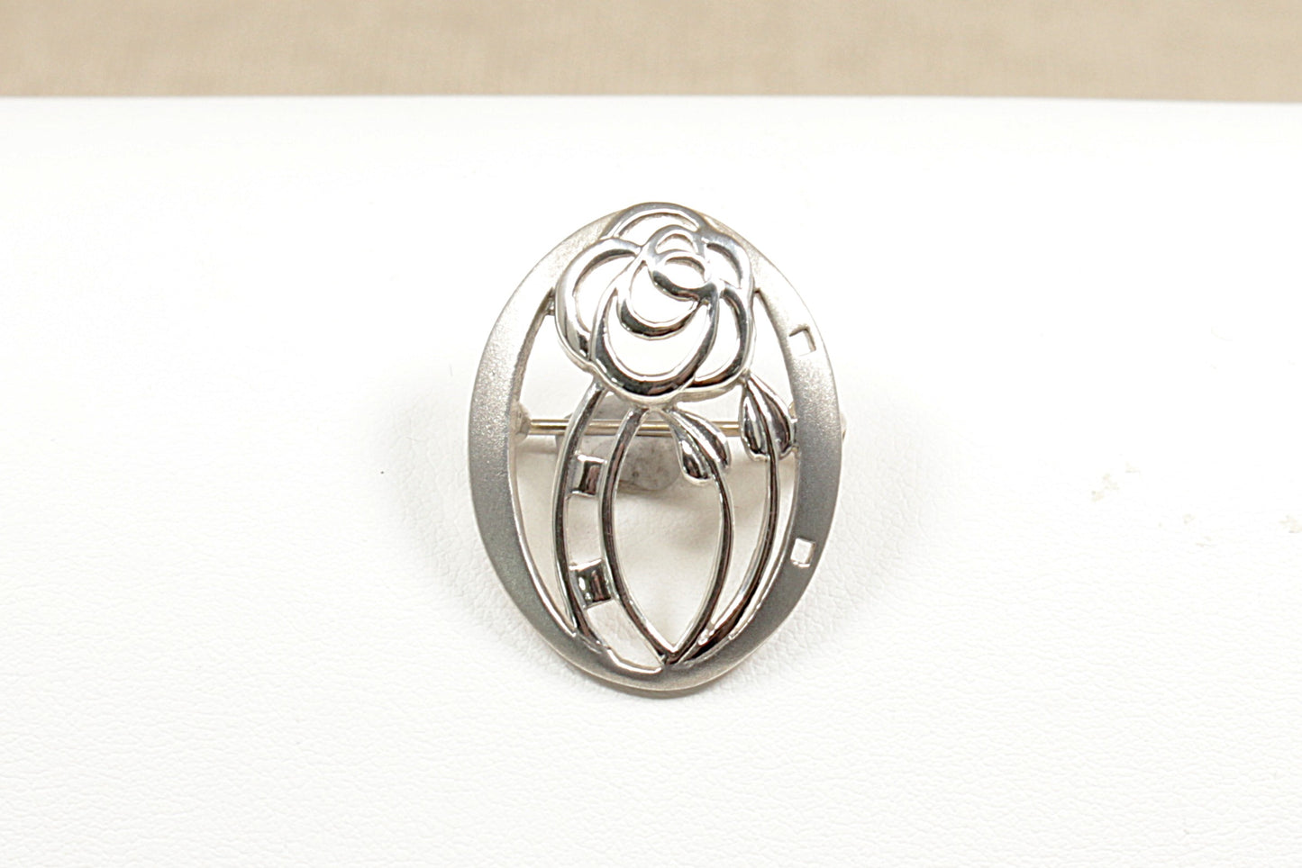 This is a beautiful, handcrafted Silver brooch by the renowned designer Kit Heath. Their designs are often inspired by nature and classic movements like Art Nouveau and this brooch has this with its graceful flowing vines and nature inspired motifs. It is in excellent condition and stamped KH and 925 for sterling silver.